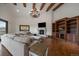 Inviting living room with high ceilings, exposed beams, fireplace, built-in shelving, and plush sofa at 214 Equinox Dr, Castle Rock, CO 80108