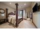 Luxurious main bedroom featuring a four-poster bed, accent pillows, and plush carpeting at 214 Equinox Dr, Castle Rock, CO 80108