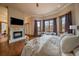 Spacious main bedroom with a fireplace, large windows, and comfortable seating area at 214 Equinox Dr, Castle Rock, CO 80108