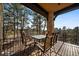 Outdoor dining on a deck with an amazing forest view and a table set for six at 214 Equinox Dr, Castle Rock, CO 80108