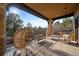 Relaxing outdoor seating area on the porch with stylish wicker chairs and a grill at 214 Equinox Dr, Castle Rock, CO 80108