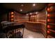 Spacious wine cellar featuring custom wood racking, tile floors, and display lighting at 214 Equinox Dr, Castle Rock, CO 80108