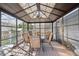 A screened-in deck with table and chairs at 13818 Krameria St, Thornton, CO 80602