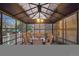 Patio furniture inside of an enclosed gazebo style structure, with wooden floors at 13818 Krameria St, Thornton, CO 80602