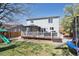 Spacious backyard with a deck, gazebo, play set, trampoline, and lush green grass at 13818 Krameria St, Thornton, CO 80602