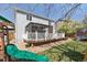 A backyard featuring a wooden deck with a gazebo, a playset, and a partially shaded lawn at 13818 Krameria St, Thornton, CO 80602
