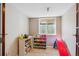 A finished basement area with colorful toy storage and a slide at 13818 Krameria St, Thornton, CO 80602