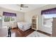 Cozy bedroom featuring wood floors, a ceiling fan, and bright, natural lighting at 13818 Krameria St, Thornton, CO 80602