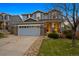Charming two-story home with stone accents, a spacious driveway, and a manicured lawn at 13818 Krameria St, Thornton, CO 80602