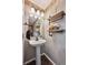 Stylish powder room with modern fixtures, decorative mirror, and attractive decor at 13818 Krameria St, Thornton, CO 80602