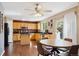 Bright kitchen with wooden cabinets, black countertops, and eat-in dining area at 13818 Krameria St, Thornton, CO 80602