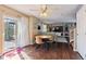 Open-concept living room with wood floors, stylish furniture, and a sliding door to the outdoor patio at 13818 Krameria St, Thornton, CO 80602