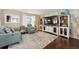 Comfortable living room with stylish furnishings, a large TV, and hardwood floors at 13818 Krameria St, Thornton, CO 80602