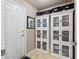 Bright mud room area featuring storage cabinets, white door, and easy access at 13818 Krameria St, Thornton, CO 80602