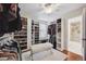 Spacious walk-in closet with custom shelves, hanging rods, and a bench on a soft rug at 13818 Krameria St, Thornton, CO 80602
