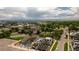 Sprawling cityscape with diverse architecture, green trees, and majestic mountain views in the distance at 2090 Eliot St, Denver, CO 80211