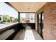 Private balcony with brick wall and views of the neighborhood with wood ceilings and black trim at 2090 Eliot St, Denver, CO 80211