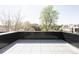 Large, tiled balcony with surrounding neighborhood and treetop views at 2090 Eliot St, Denver, CO 80211