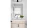 Well-lit bathroom with modern vanity and sleek mirror at 2090 Eliot St, Denver, CO 80211