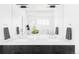 Dual sink bathroom vanity with a black wood base, white counter and chrome fixtures at 2090 Eliot St, Denver, CO 80211