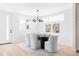Modern dining room with statement artwork, sleek black dining table, and comfortable seating for six at 2090 Eliot St, Denver, CO 80211