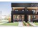 Striking exterior showcases a brick facade, black metal accents, and manicured landscaping at 2090 Eliot St, Denver, CO 80211