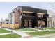 Stunning three-story home boasts sleek, modern architecture with a red brick facade and black metal accents at 2090 Eliot St, Denver, CO 80211