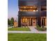 Contemporary townhome boasts a brick facade, covered balcony, and stylish front entrance with modern accents at 2090 Eliot St, Denver, CO 80211
