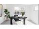 Bright home office with large picture window and modern dark desk and chairs at 2090 Eliot St, Denver, CO 80211