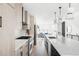 Bright, open kitchen featuring modern appliances, island with white marble countertop, and pendant lighting at 2090 Eliot St, Denver, CO 80211