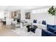 Bright and airy living room features stylish furnishings and seamless flow to the modern kitchen at 2090 Eliot St, Denver, CO 80211