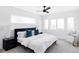 Serene main bedroom boasts a plush bed with blue accents, contemporary lighting, and ample natural light at 2090 Eliot St, Denver, CO 80211