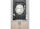 Chic powder room featuring textured dark wall, round mirror, modern light fixture and floating vanity at 2090 Eliot St, Denver, CO 80211