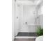 Glass enclosed shower with a rain shower head, handheld wand and corner bench at 2090 Eliot St, Denver, CO 80211