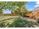 Landscaped backyard with deck and wooden fence at 11480 Moline St, Commerce City, CO 80640