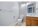 Simple bathroom with wood vanity and updated toilet at 11480 Moline St, Commerce City, CO 80640