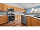 Spacious kitchen with stainless steel appliances and updated backsplash at 11480 Moline St, Commerce City, CO 80640