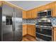 Modern kitchen with stainless steel appliances and wood cabinets at 11480 Moline St, Commerce City, CO 80640