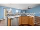 Modern kitchen with updated backsplash and stainless steel dishwasher at 11480 Moline St, Commerce City, CO 80640