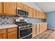 Modern kitchen with stainless steel appliances and updated backsplash at 11480 Moline St, Commerce City, CO 80640