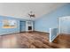 Spacious living room with hardwood floors, fireplace, and ceiling fan at 11480 Moline St, Commerce City, CO 80640