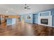Open living room and kitchen with hardwood floors and vaulted ceiling at 11480 Moline St, Commerce City, CO 80640
