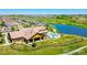 Stunning aerial view of a community clubhouse, pool, and lush golf course with water features at 19802 E 54Th Ave, Denver, CO 80249