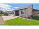 Backyard with a well maintained lawn, concrete patio and covered patio at 19802 E 54Th Ave, Denver, CO 80249