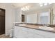 Bathroom features double vanity sinks with framed mirrors and a walk-in shower at 19802 E 54Th Ave, Denver, CO 80249