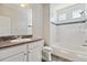 Bright bathroom with tiled shower and backsplash and a vanity sink with a large mirror at 19802 E 54Th Ave, Denver, CO 80249