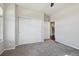 Bedroom with a ceiling fan, sliding closet doors, and plush carpet flooring at 19802 E 54Th Ave, Denver, CO 80249