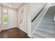 Foyer with hardwood floors, staircase, and a front door that lets in natural light at 19802 E 54Th Ave, Denver, CO 80249