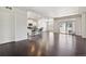 Open-concept living room featuring hardwood floors, recessed lighting, and access to an outdoor patio area at 19802 E 54Th Ave, Denver, CO 80249