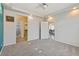 Spacious main bedroom features plush carpeting, a ceiling fan, and access to ensuite bathroom and closet at 19802 E 54Th Ave, Denver, CO 80249